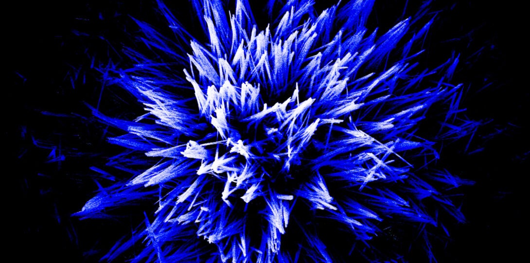 Blue and white spikes erupting from a black background.