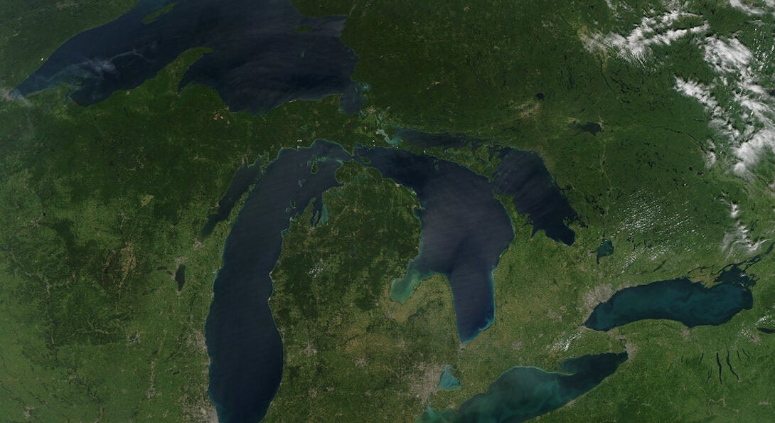 A satellite image shows the blue Great Lakes against green land.