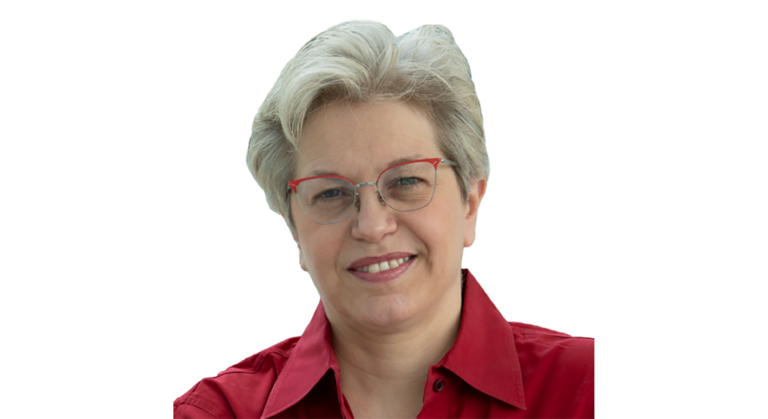 A woman with glasses wearing a red collared shirt.