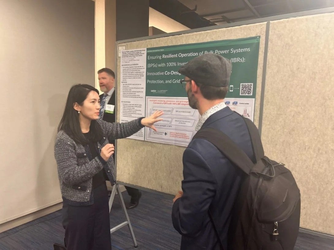 A woman presents research on a board to a man in a backpack.